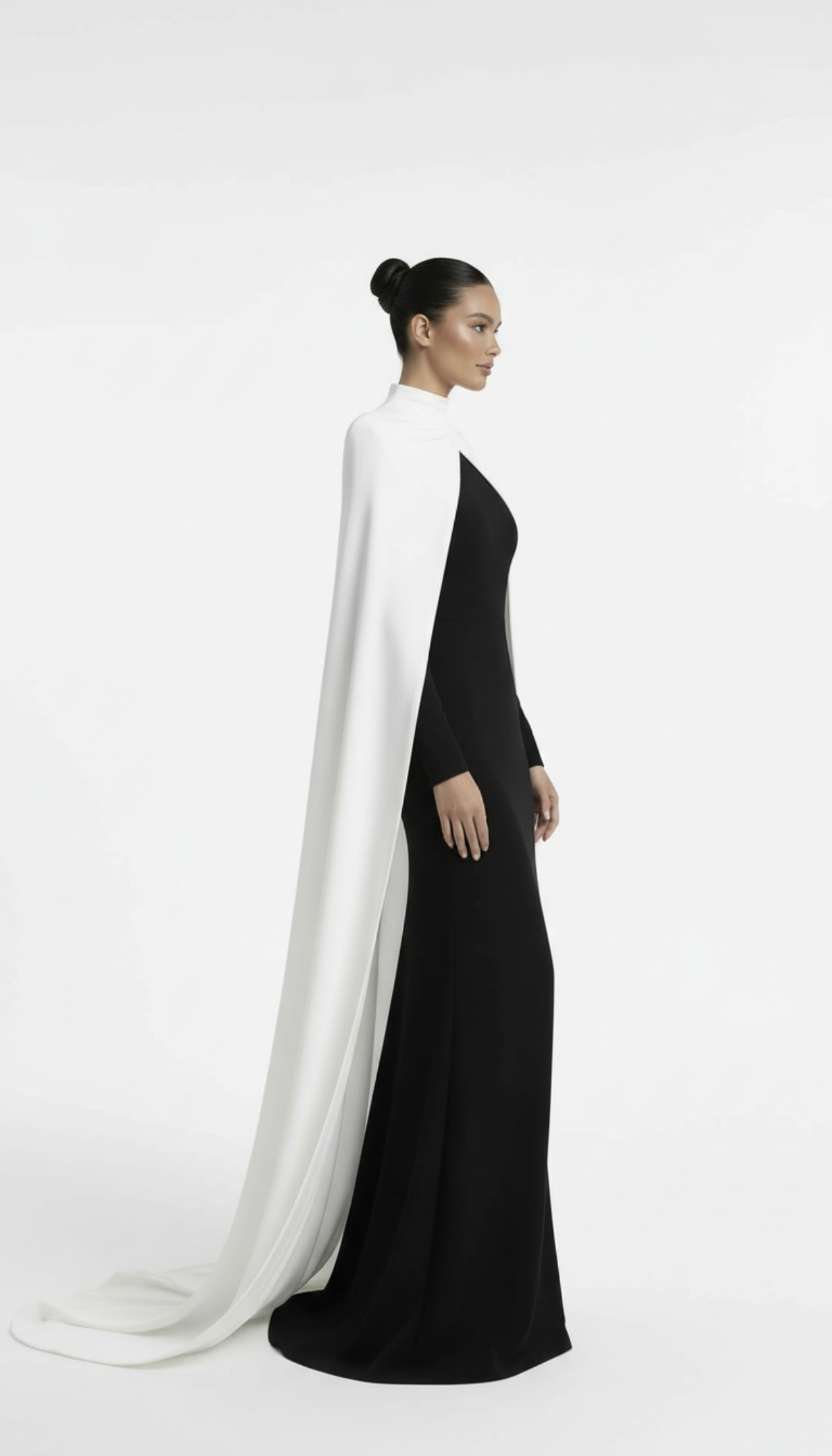 Woman wearing a black dress with a white cape on a white background