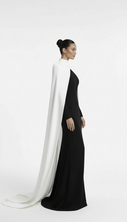 Woman wearing a black dress with a white cape on a white background