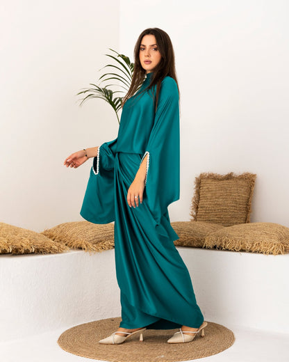 Teal modest outfit with flowy sleeves and draped skirt, side view