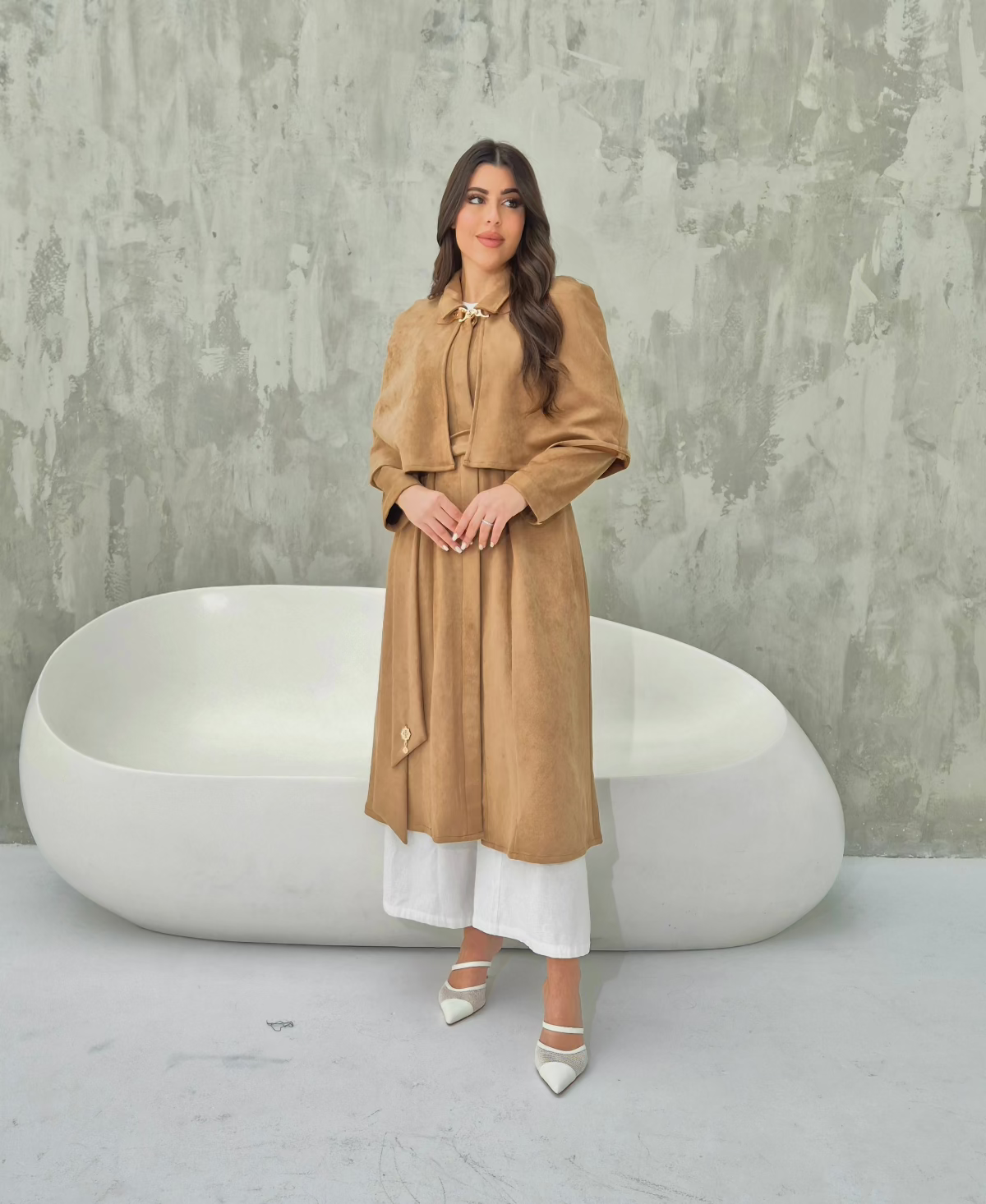 camel suede cape coat, highlighting its flowy silhouette and luxurious texture