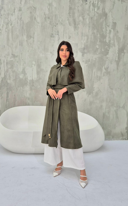 Model wearing convertible khaki suede cape coat with detachable short cape for versatile styling.