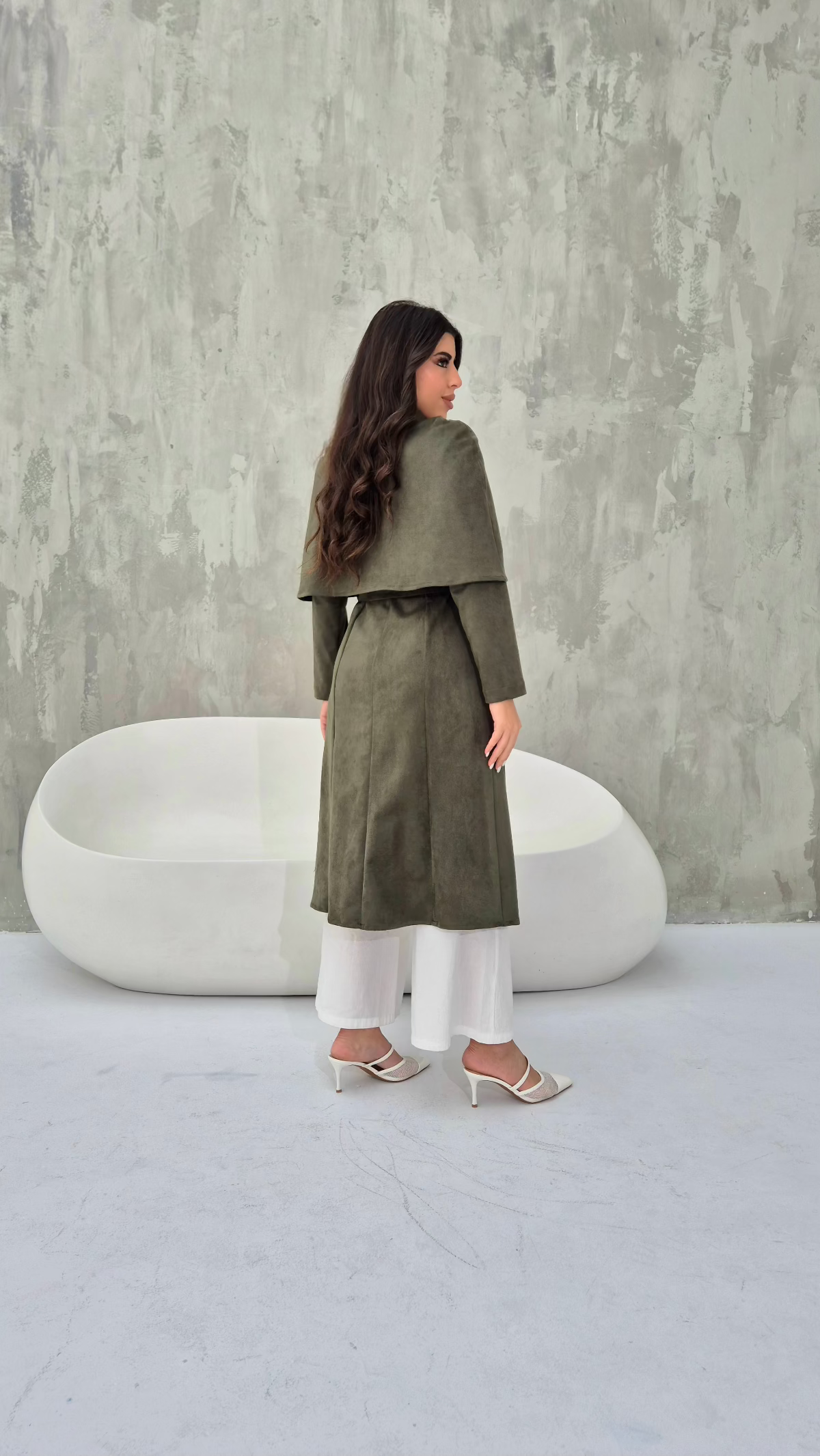 Back view of the khaki suede cape coat, showcasing its flowy silhouette and elegant tailoring.