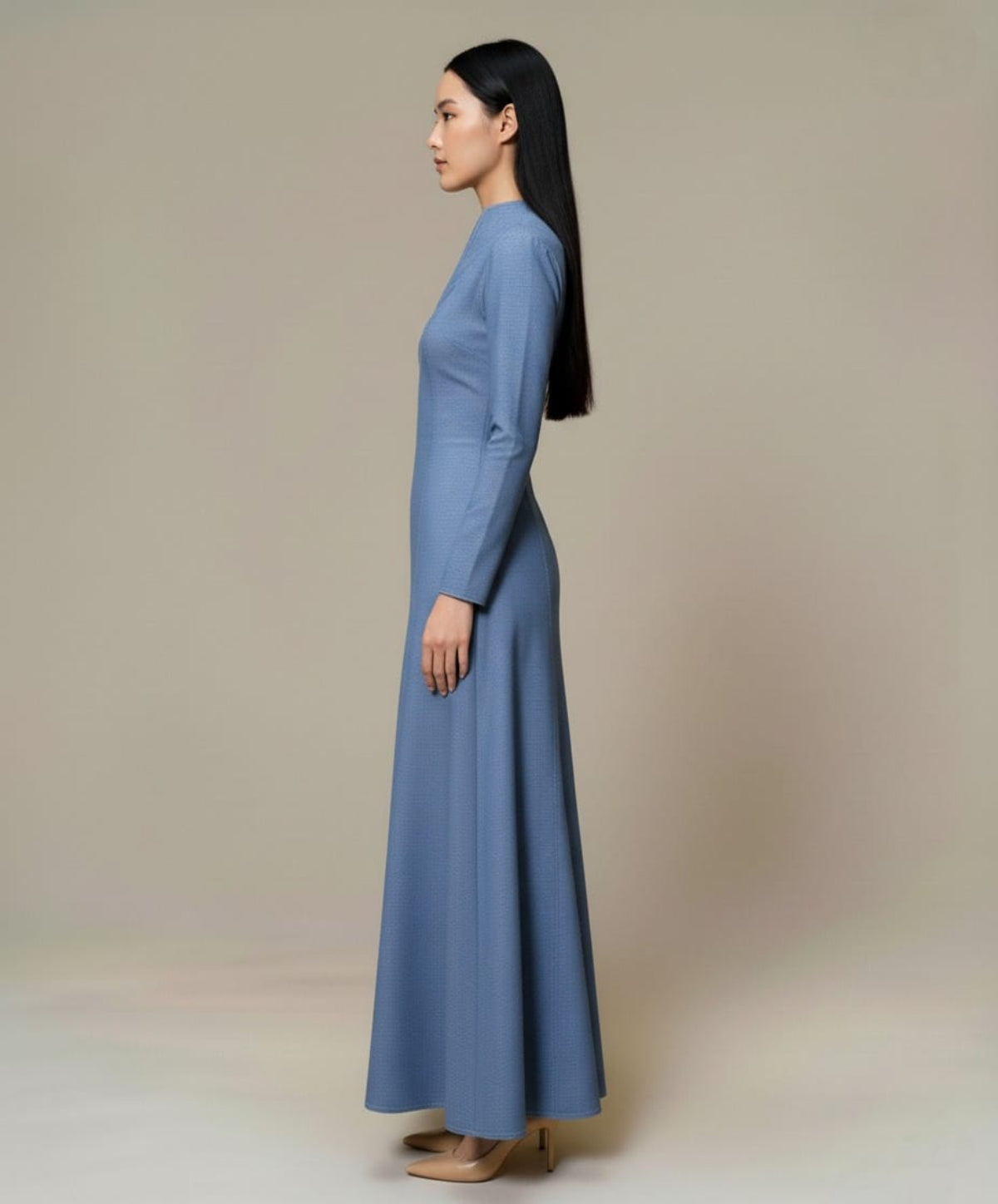 light blue denim maxi dress featuring long sleeves, a fitted waist, and a flowing full-length.