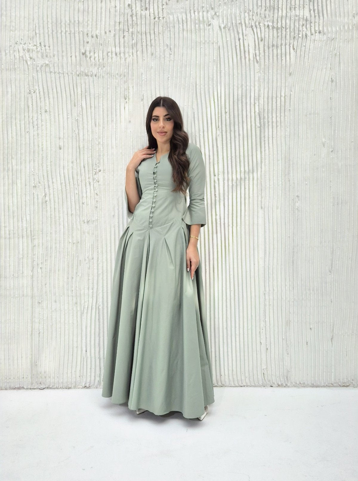 Full-length view of the pleated A-line silhouette of the Sage Maxi Dress
