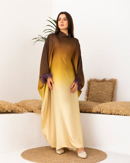 Modest satin kaftan in brown and gold ombré with feathered sleeves, worn by a model. Free-size with a matching scarf.